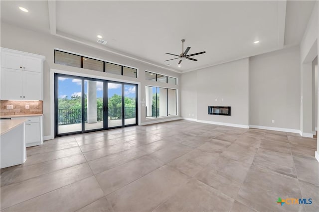 6846 Spring Branch Rd, Spring Branch, TX 78070 - unfurnished living room with ceiling fan, recessed lighting, a glass covered fireplace, and baseboards