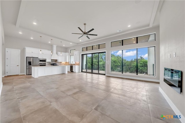 6846 Spring Branch Rd, Spring Branch, TX 78070 - unfurnished living room featuring ceiling fan, recessed lighting, baseboards, and a towering ceiling