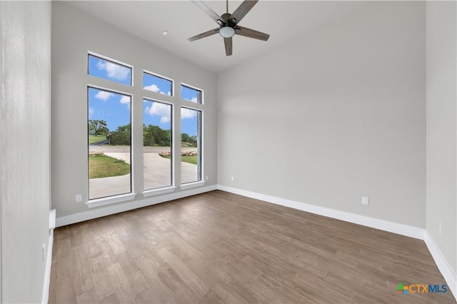 6846 Spring Branch Rd, Spring Branch, TX 78070 - spare room with wood finished floors, baseboards, ceiling fan, and a high ceiling