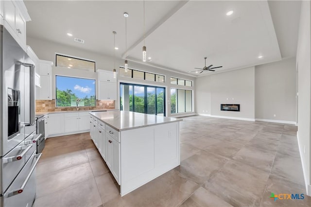 6846 Spring Branch Rd, Spring Branch, TX 78070 - kitchen featuring a ceiling fan, high end refrigerator, backsplash, light countertops, and a center island