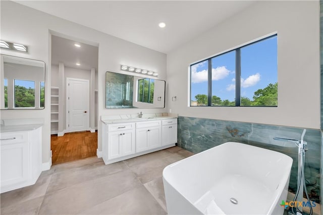 6846 Spring Branch Rd, Spring Branch, TX 78070 - full bath featuring plenty of natural light, vanity, a freestanding bath, recessed lighting, and tile walls