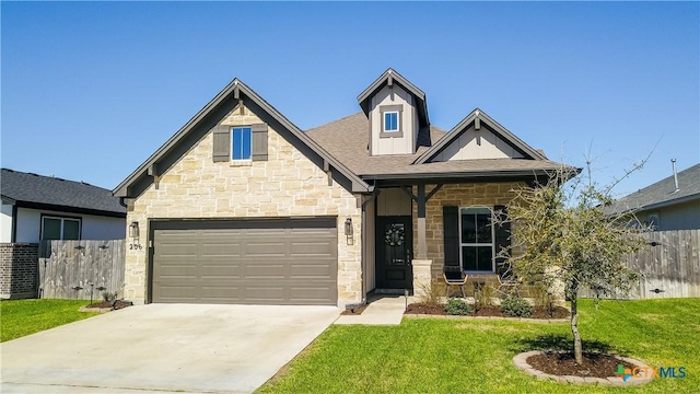 view of front of home with a front yard, fence, and driveway