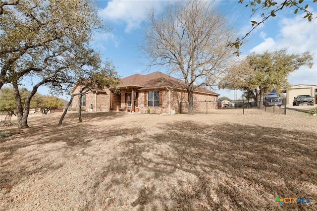 ranch-style home featuring fence