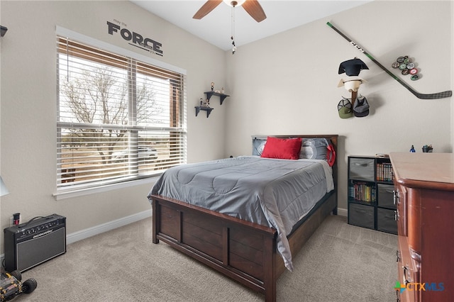 carpeted bedroom featuring baseboards and ceiling fan