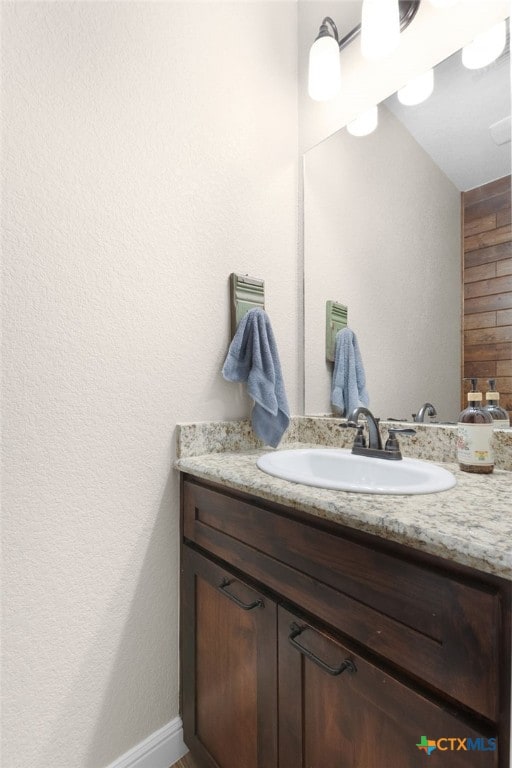 bathroom featuring vanity and baseboards