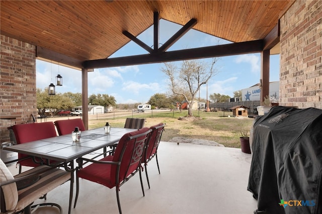 view of patio featuring outdoor dining area, a fenced backyard, and grilling area