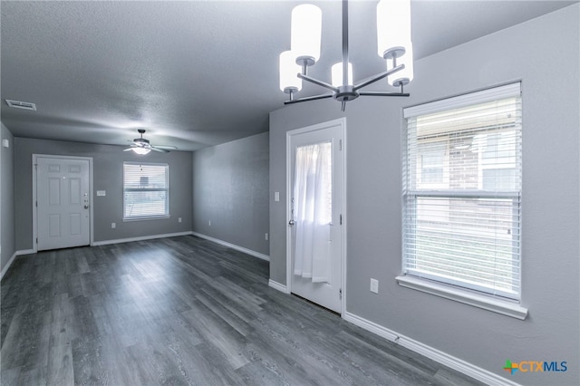 entryway featuring a textured ceiling, dark wood-type flooring, and ceiling fan with notable chandelier