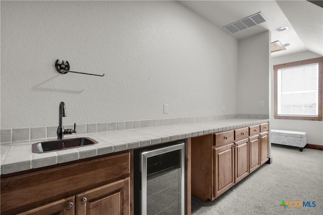 12491 Madison Ln, Justin, TX 76247 - bar with beverage cooler, a sink, lofted ceiling, and light colored carpet