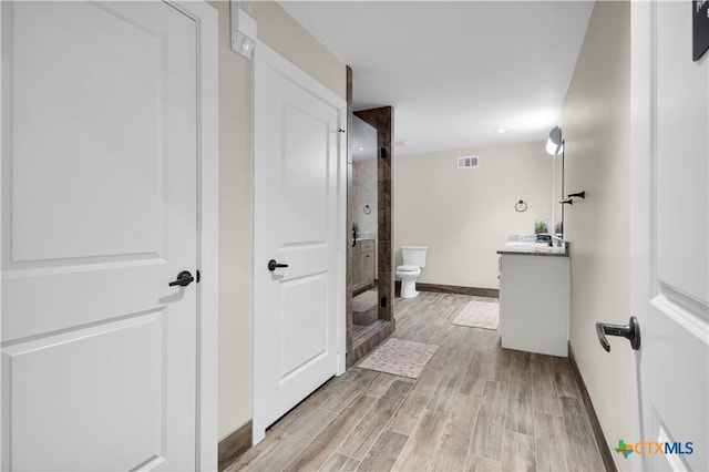 12491 Madison Ln, Justin, TX 76247 - bathroom featuring vanity, a shower, wood finished floors, toilet, and baseboards