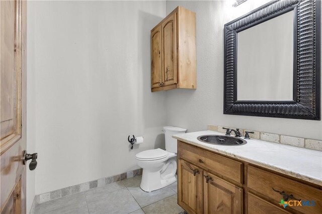 12491 Madison Ln, Justin, TX 76247 - bathroom featuring toilet, baseboards, vanity, and tile patterned flooring