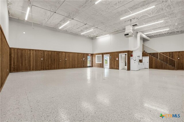 12491 Madison Ln, Justin, TX 76247 - garage featuring wood walls and a wainscoted wall