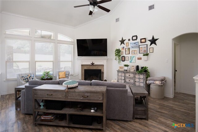 3608 Quail Ridge Dr, Harker Heights, TX 76548 - living room with arched walkways, a ceiling fan, ornamental molding, a tiled fireplace, and plenty of natural light