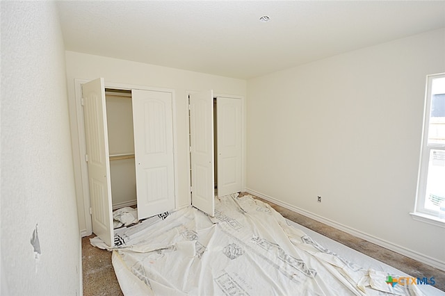 carpeted bedroom with multiple windows