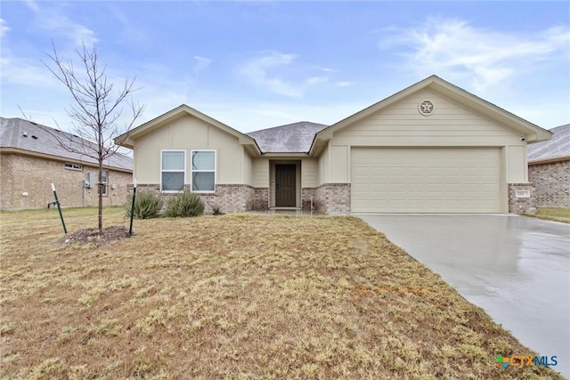 ranch-style house with brick siding, a front lawn, concrete driveway, and a garage