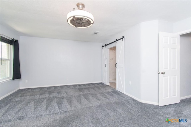 1517 Iris Ave, Killeen, TX 76543 - unfurnished room with carpet floors, a barn door, and baseboards