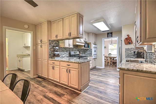 3117 Magnolia Blvd, Temple, TX 76502 - kitchen featuring stainless steel appliances, a textured ceiling, tasteful backsplash, and dark wood-type flooring
