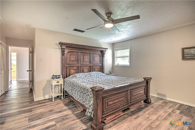 3117 Magnolia Blvd, Temple, TX 76502 - bedroom featuring a textured ceiling, wood finished floors, and ceiling fan