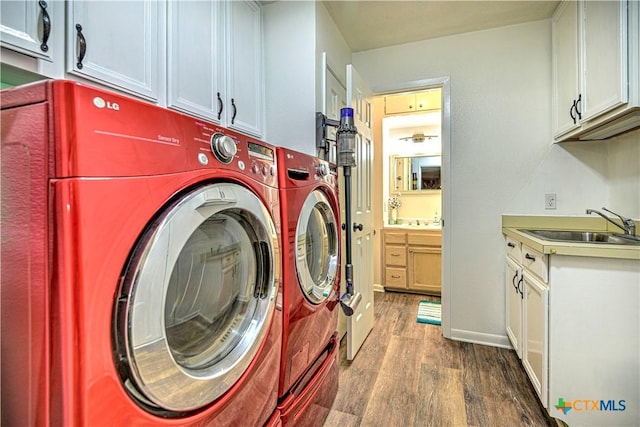3117 Magnolia Blvd, Temple, TX 76502 - laundry room with cabinet space, wood finished floors, and separate washer and dryer
