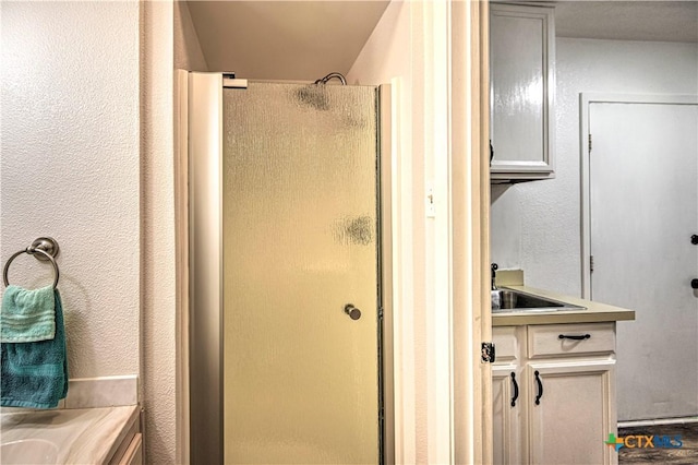 3117 Magnolia Blvd, Temple, TX 76502 - bathroom with a shower stall, vanity, and a textured wall