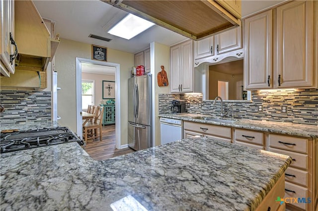 3117 Magnolia Blvd, Temple, TX 76502 - kitchen featuring freestanding refrigerator, dishwasher, wood finished floors, tasteful backsplash, and light stone counters