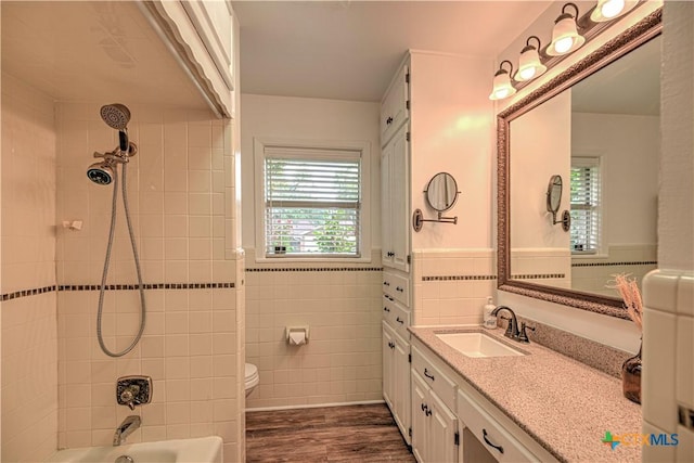 3117 Magnolia Blvd, Temple, TX 76502 - bathroom with vanity, wood finished floors, bathing tub / shower combination, and tile walls