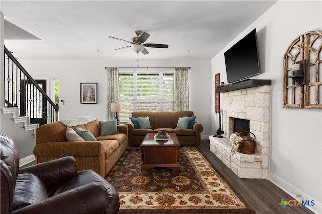 127 Diamond Head Dr, Bastrop, TX 78602 - living area with dark wood-style floors, a ceiling fan, baseboards, stairway, and a fireplace