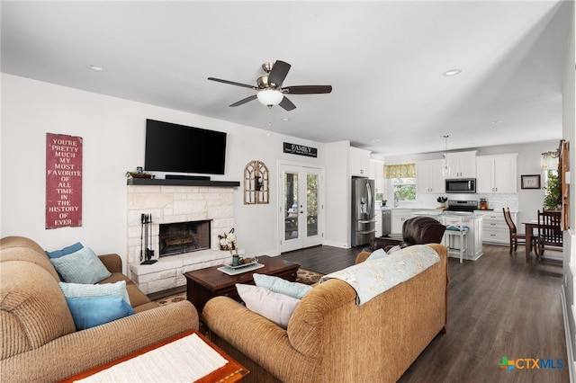 127 Diamond Head Dr, Bastrop, TX 78602 - living area featuring a ceiling fan, dark wood-style flooring, recessed lighting, and a stone fireplace