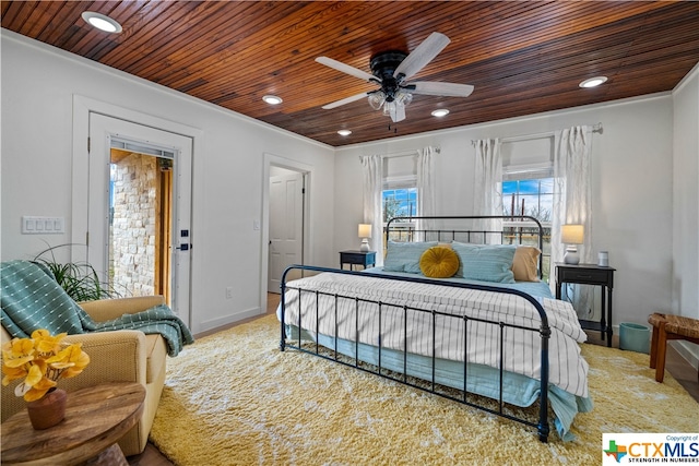 bedroom with ornamental molding, ceiling fan, and wood ceiling