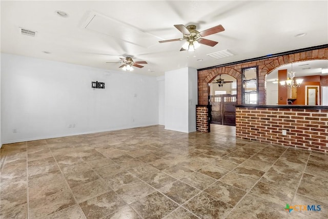 unfurnished living room with arched walkways, visible vents, and ceiling fan