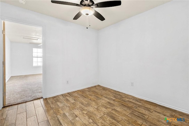 unfurnished room with a ceiling fan, light wood-style floors, and baseboards