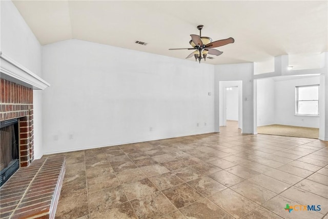 unfurnished living room featuring visible vents, a ceiling fan, baseboards, a brick fireplace, and vaulted ceiling