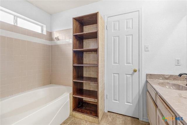 full bath featuring vanity and a washtub