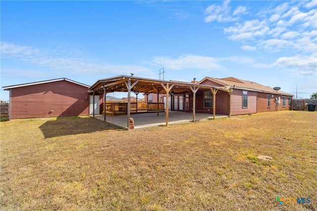 back of property with a patio and a lawn