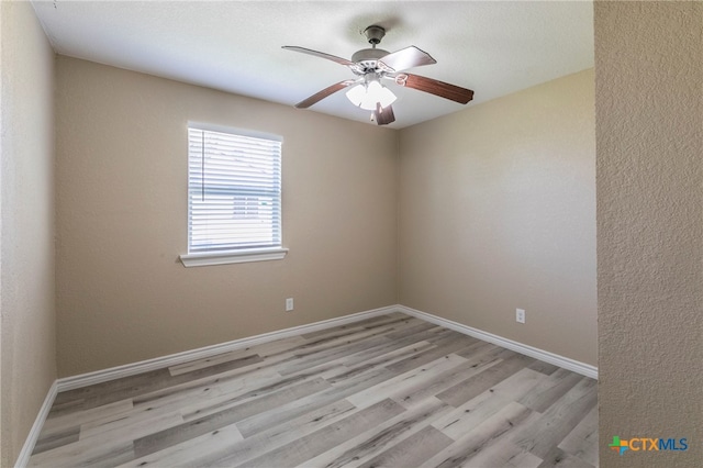 spare room featuring ceiling fan and light hardwood / wood-style floors