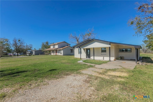 rear view of property featuring a yard and a porch