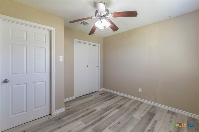 unfurnished bedroom with a closet, ceiling fan, and light hardwood / wood-style flooring