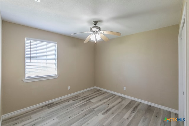 unfurnished room featuring ceiling fan, a textured ceiling, and light hardwood / wood-style flooring