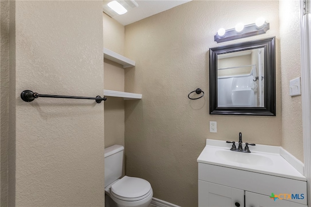 bathroom with vanity and toilet