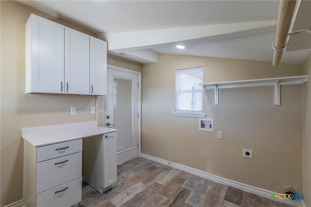 clothes washing area featuring hookup for an electric dryer, hookup for a washing machine, light wood-type flooring, and cabinets