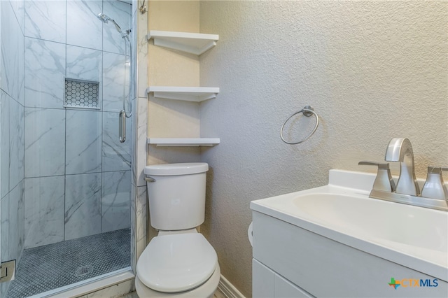 bathroom with vanity, an enclosed shower, and toilet