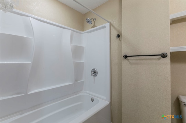 bathroom with toilet and tub / shower combination