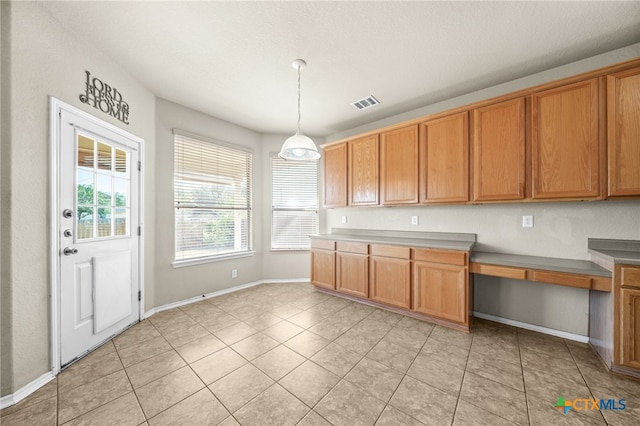 kitchen featuring light tile patterned floors and decorative light fixtures