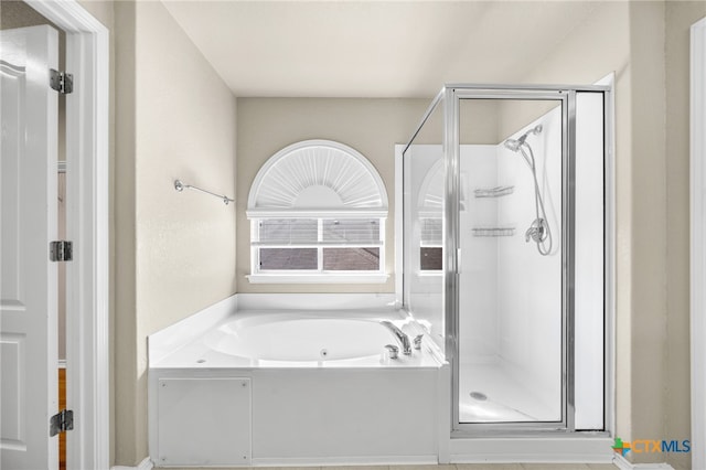 bathroom with shower with separate bathtub