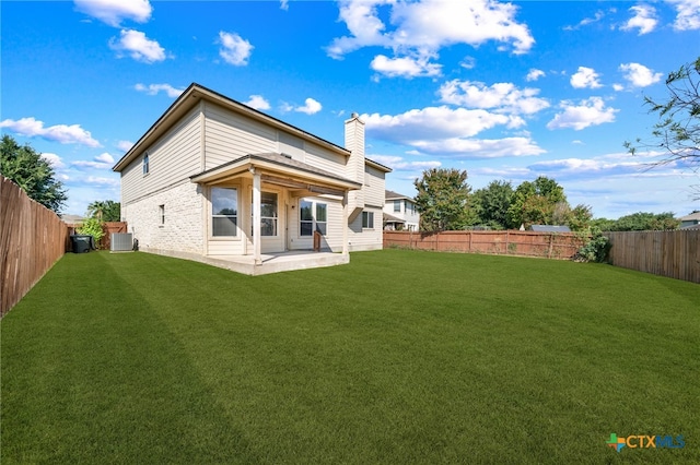 back of house with central AC unit, a yard, and a patio area