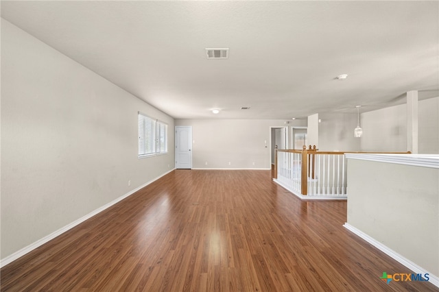 spare room featuring dark wood-type flooring