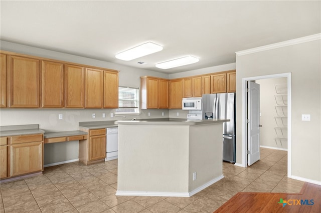 kitchen with white appliances, light tile patterned flooring, and a center island