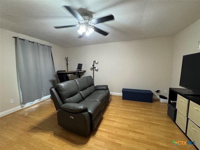 305 Ivy Ave, Luling, TX 78648 - living room with a textured ceiling, a ceiling fan, light wood finished floors, and baseboards