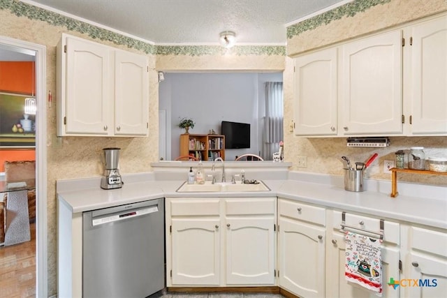 4313 Lone Star Trl, Temple, TX 76502 - kitchen with stainless steel dishwasher, a sink, light countertops, white cabinetry, and a textured ceiling
