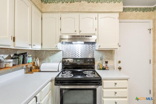 4313 Lone Star Trl, Temple, TX 76502 - kitchen featuring stainless steel range with electric stovetop, extractor fan, light countertops, backsplash, and white cabinetry