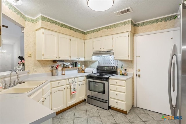 4313 Lone Star Trl, Temple, TX 76502 - kitchen with electric stove, a sink, under cabinet range hood, a textured ceiling, and light tile patterned floors